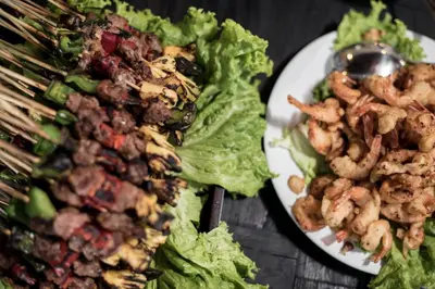 a plate of food with lettuce and shrimp on it at Villa Gardenia - 6 Bedrooms with Pool in Seminyak in Seminyak