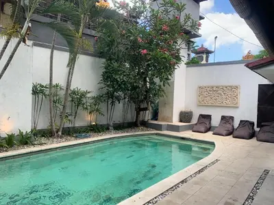 a swimming pool in front of a house at Villa Gardenia - 6 Bedrooms with Pool in Seminyak in Seminyak