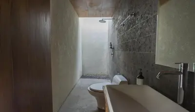 a bathroom with a toilet and a bath tub at Rarama Teba Villa in Umalas