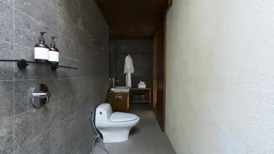 a bathroom with a toilet and a sink at Rarama Teba Villa in Umalas