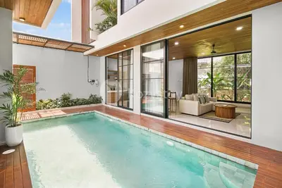 an indoor swimming pool in a house at Kanani Villa by Kozystay - Umalas in Seminyak