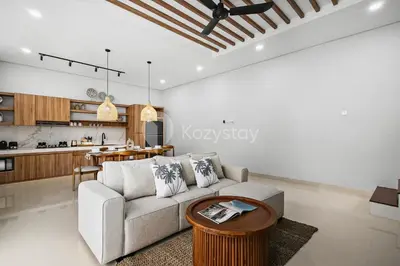 a living room with a couch and a table at Verde Villa by Kozystay - Umalas in Kerobokan