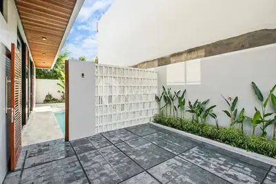 an internal courtyard of a house with plants at Verde Villa by Kozystay - Umalas in Kerobokan