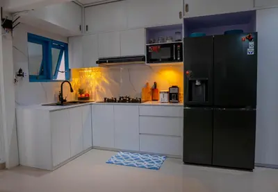 a kitchen with a black refrigerator and white cabinets at Altea Villa Legian - 2BR Private Pool, Prime Location & Walk to Beach in Legian