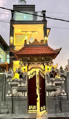 a yellow building with a red roof at Shin In Bali in Kuta