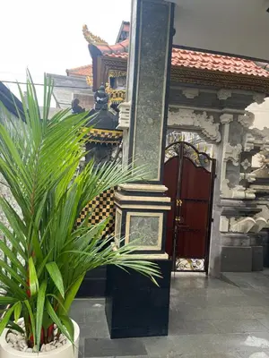 a potted plant sitting in front of a building at Shin In Bali in Kuta
