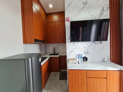 a kitchen with marble counter tops and a refrigerator at Shin In Bali in Kuta