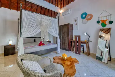 a bedroom with a bed and a table and chairs at Peaceful 2bd Seminyak villa with Private Pool and Garden in Seminyak