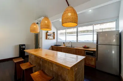 a kitchen with a counter and a refrigerator at Villa Bardo by Pertama Management in Seminyak
