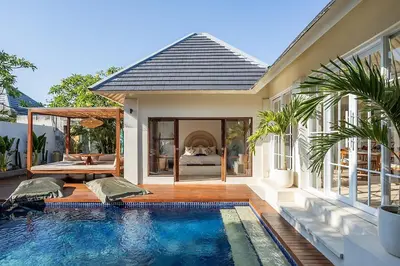 a house with a swimming pool next to a bedroom at Villa Dalon by Optimum Bali Villas in Seminyak