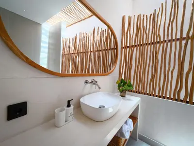 a bathroom with a white sink and a mirror at Miko Villa Seminyak in Seminyak