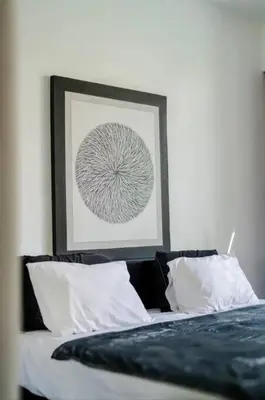 a bedroom with a bed with a picture above it at Villa bella vista in Seminyak