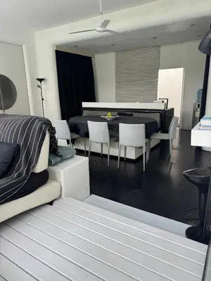 a living room with a table and a dining room at Villa bella vista in Seminyak