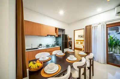 a kitchen with a dining room table and chairs at Promo!! New Rosa Villa Muding, Luxury and cozy 3Bedrooms Villa in Heart of Kerobokan with Special Office Room in Kerobokan