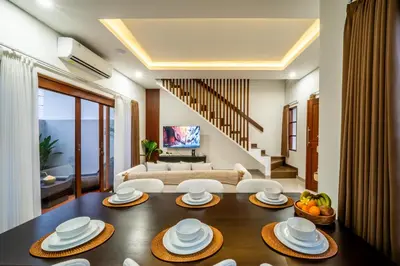 a living room with a table and a couch at Promo!! New Rosa Villa Muding, Luxury and cozy 3Bedrooms Villa in Heart of Kerobokan with Special Office Room in Kerobokan