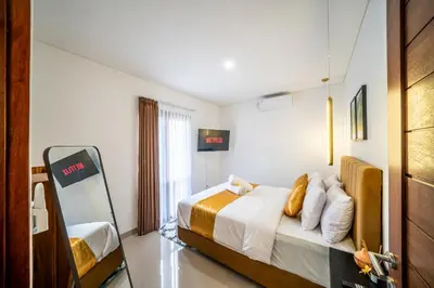 a hotel room with a bed and a mirror at Promo!! New Rosa Villa Muding, Luxury and cozy 3Bedrooms Villa in Heart of Kerobokan with Special Office Room in Kerobokan