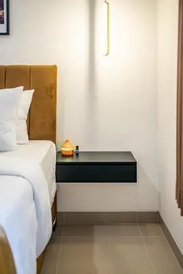 a bedroom with a bed and a table next to a bed at Promo!! New Rosa Villa Muding, Luxury and cozy 3Bedrooms Villa in Heart of Kerobokan with Special Office Room in Kerobokan