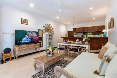 a living room with a couch and a tv at Bens Tunjung Villa Two-Bedroom with Private Pool Kuta in Seminyak