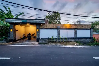 a building with a motorcycle parked in the garage at Bens Tunjung Villa Two-Bedroom with Private Pool Kuta in Seminyak