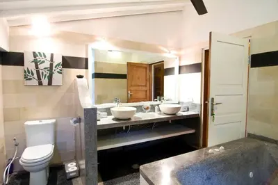a bathroom with two sinks and a toilet at Villa Kija in Seminyak