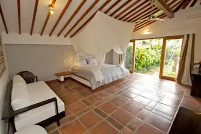 a bedroom with a bed and a couch in a room at Villa Kija in Seminyak