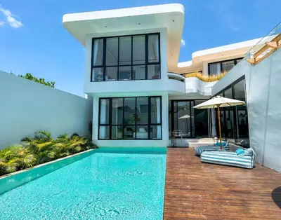 a house with a swimming pool in front of it at Villa Kalem Canggu by Nakula in Canggu