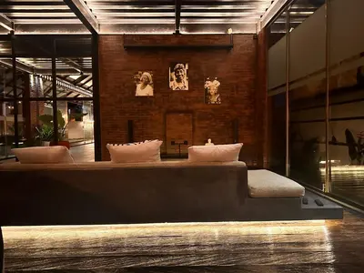 a room with a bed with pillows on it at The Edge by Anima in Kerobokan