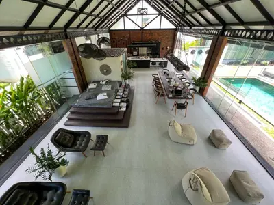 a large room with tables and chairs and a pool at The Edge by Anima in Kerobokan