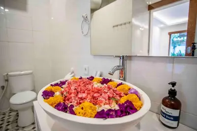 a bath tub filled with flowers in a bathroom at Bens Mertanadi Villa Two-Bedroom with Private Pool Kuta in Seminyak