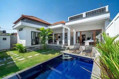 a villa with a swimming pool and a house at Viewbali 2- Modern Villa with Stunning Rooftop Views in Kerobokan