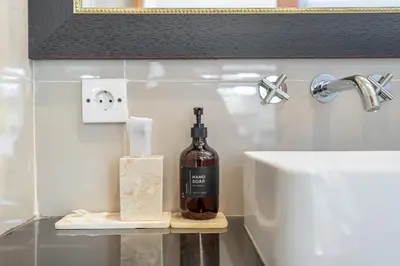 a bottle of wine sitting on a shelf next to a sink at Viewbali 2- Modern Villa with Stunning Rooftop Views in Kerobokan