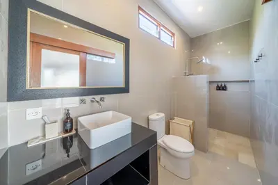 a white bathroom with a sink and a toilet at Viewbali 2- Modern Villa with Stunning Rooftop Views in Kerobokan
