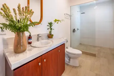 a bathroom with a sink and a toilet and a mirror at Arts Biyu Villa Two-Bedroom with Private Pool Kuta in Seminyak