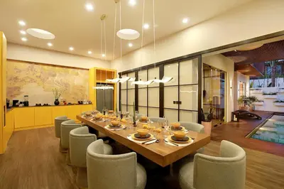 a dining room with a long table and chairs at CANGGU BRAND NEW 6Bed VILLA! BEST LOCATION! A STEP-FREE Design Highlight for Families & Friends in Canggu