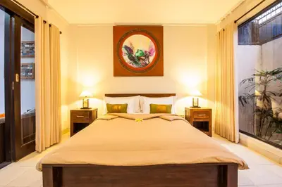 a bedroom with a large bed with two night stands at 4-BR Private Pool Legian Villa, 5-min walk to beach and shops in Seminyak