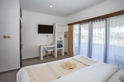 a bedroom with a bed with a hat on it at Baliterraneo Boutique Resort Seminyak in Seminyak