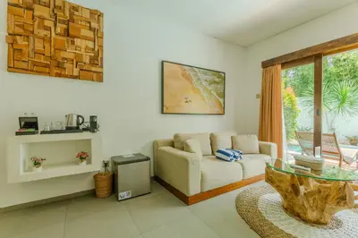 a living room with a couch and a table at Baliterraneo Boutique Resort Seminyak in Seminyak
