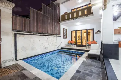 a swimming pool in a house with a house at 8-BR Private Pool Legian Villa 5-min Walk to Beach and Shops in Seminyak