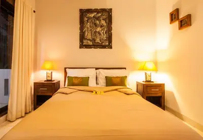 a bedroom with a large bed with two lamps at 10-BR Private Pool Legian Villa 5-Min Walk to Beach and Shops in Seminyak