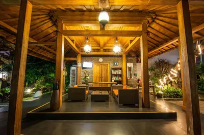 a large wooden pavilion with chairs and a table at 6-BR Garden Legian Villa 5-Min Walk to Beach and Shops Bali in Seminyak