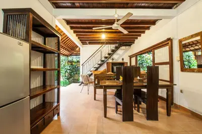 a dining room with a table and a ceiling fan at 6-BR Garden Legian Villa 5-Min Walk to Beach and Shops Bali in Seminyak