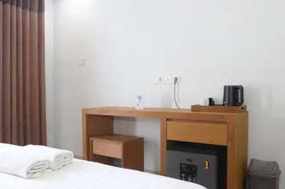a desk in a room with a bed and a desk at Ronta Bungalows in Legian