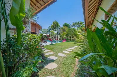 a garden path leading to a swimming pool at Villa Lea - 5BR luxury oasis in Seminyak with pool in Kerobokan