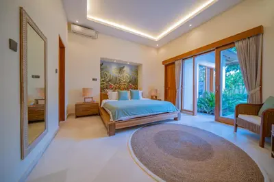 a bedroom with a bed and a large window at Villa Lea - 5BR luxury oasis in Seminyak with pool in Kerobokan