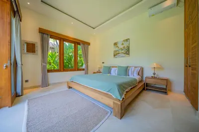 a bedroom with a bed and a window at Villa Lea - 5BR luxury oasis in Seminyak with pool in Kerobokan