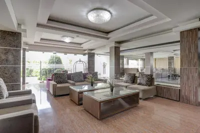 a living room with couches and a table at Townhouse Oak Denpasar at Mahendradatta in Denpasar