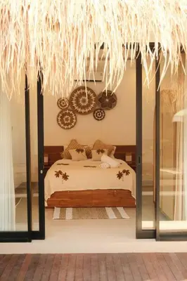 a bedroom with a bed and a large window at Amethyst Villa Seminyak in Seminyak