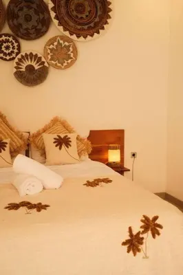 a bedroom with a bed with plates on the wall at Amethyst Villa Seminyak in Seminyak