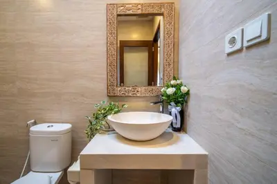 a bathroom with a bowl sink and a mirror at Arts Cherry Villa Satu Two-Bedroom with Private Pool Kuta in Kerobokan