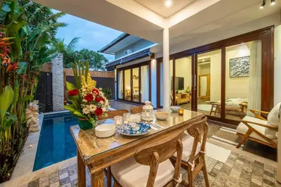 a dining room with a table and a pool at Arts Cherry Villa Satu Two-Bedroom with Private Pool Kuta in Kerobokan